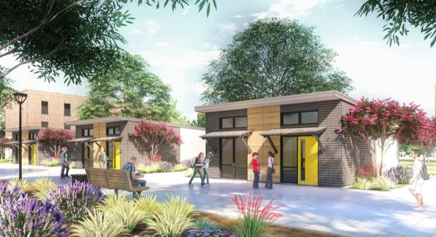 Modern modular building with yellow door in a park-like setting