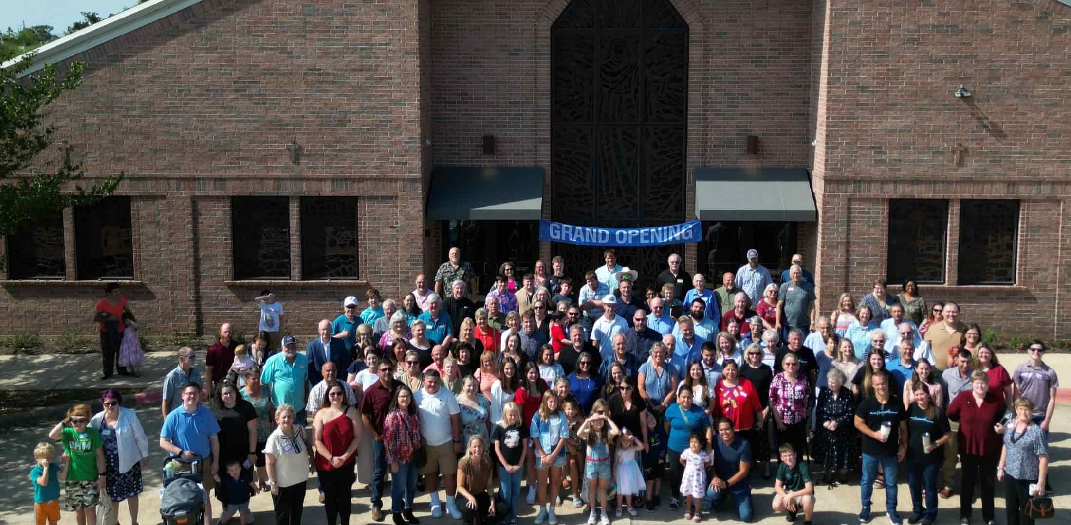 church members gathered in front on the building for a group picture at our Grand Opening