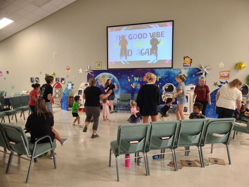 children and adults dancing and singing at VBS